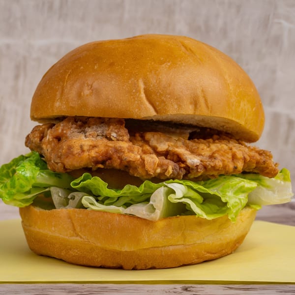 Stanton's City Bites' crispy fried chicken sandwich with fresh lettuce on a toasted bun.
