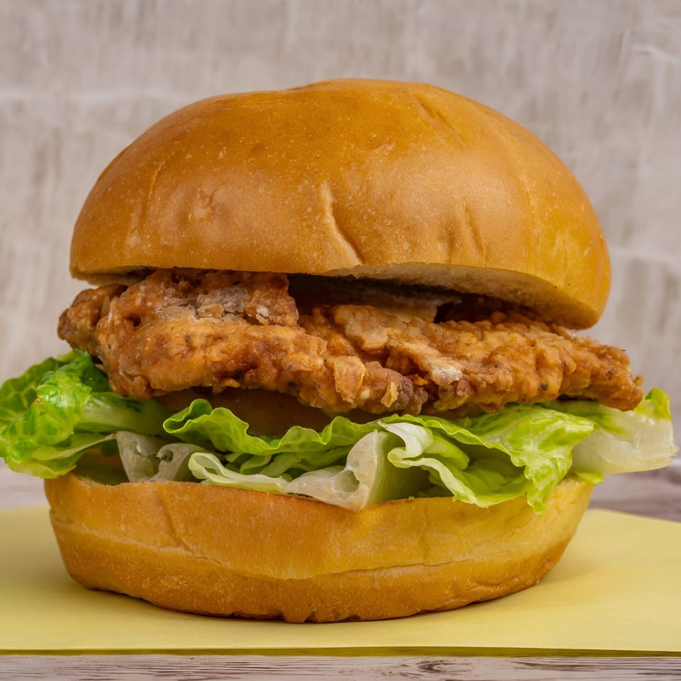 Stanton's City Bites' crispy fried chicken sandwich with fresh lettuce on a toasted bun.